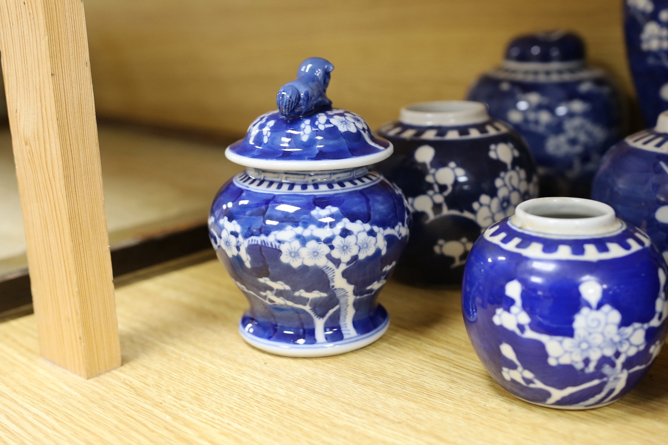 A group of Chinese blue and white prunus vases and jars and covers and jars, pair of vases 23 cms high